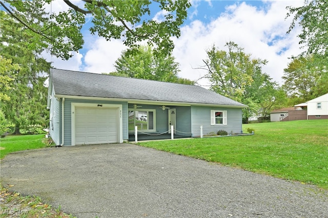 ranch-style house with a garage and a front lawn