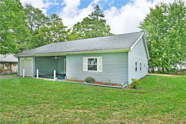 exterior space with a garage and a yard