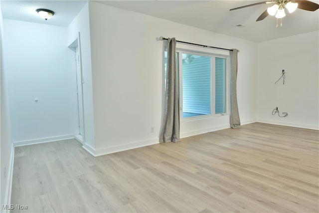 spare room featuring ceiling fan and light hardwood / wood-style flooring