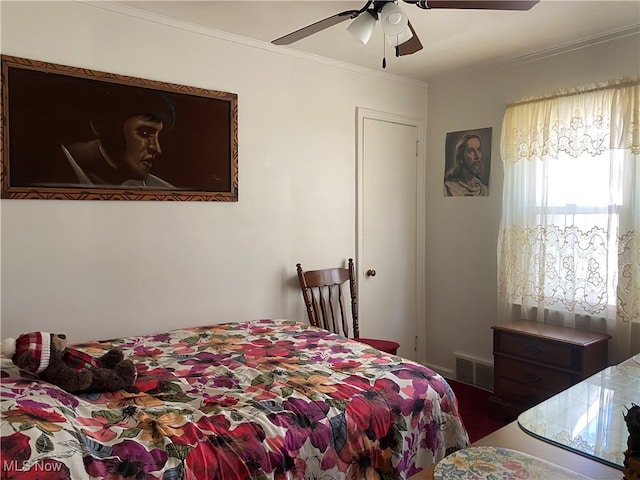 bedroom with ceiling fan and crown molding