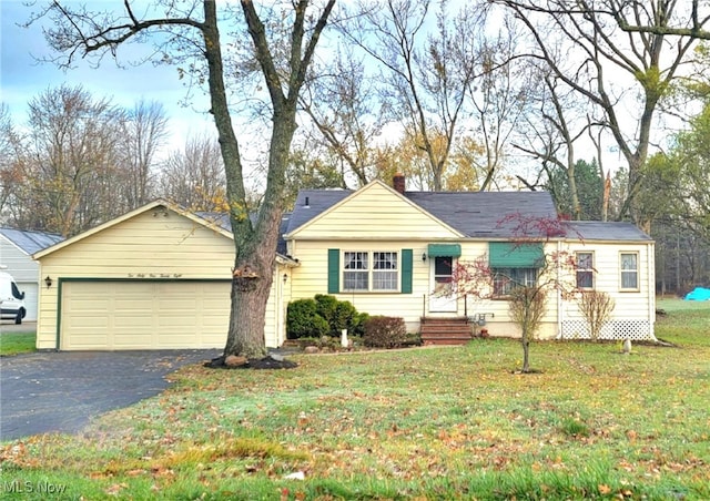 single story home with a front yard and a garage