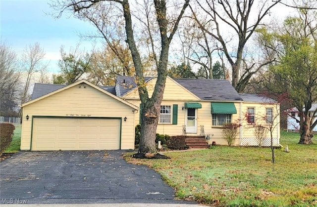 ranch-style house with a garage and a front yard