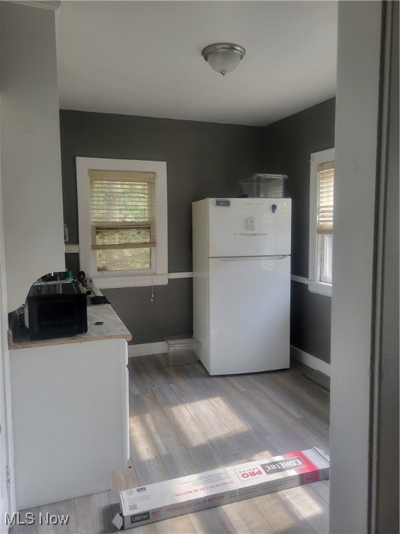 kitchen featuring light hardwood / wood-style flooring and white refrigerator