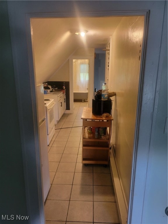 interior space with lofted ceiling and light tile patterned floors