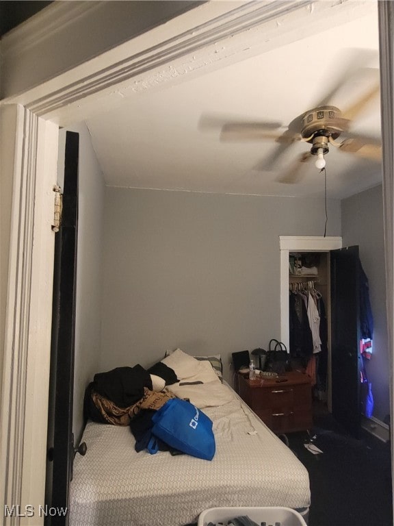 bedroom featuring carpet floors, vaulted ceiling, ceiling fan, and a closet