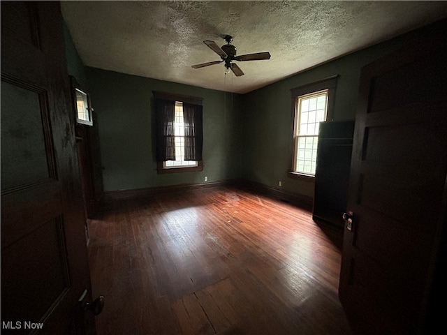 unfurnished bedroom with ceiling fan, hardwood / wood-style flooring, and a textured ceiling