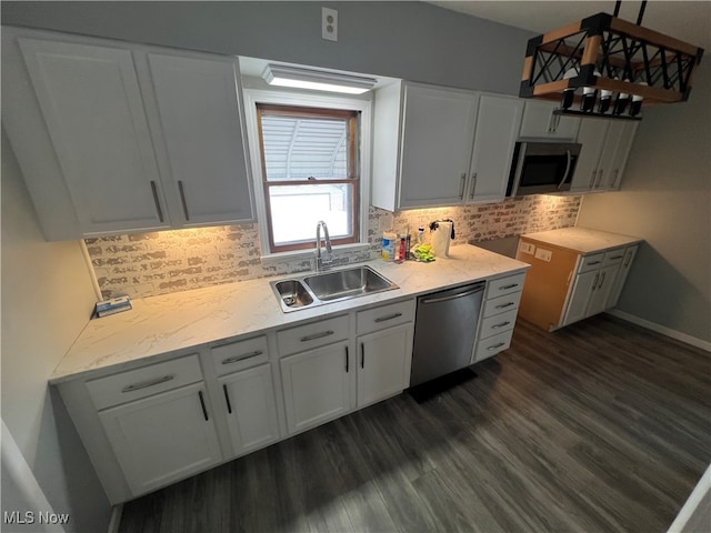 kitchen featuring pendant lighting, white cabinets, stainless steel appliances, and sink