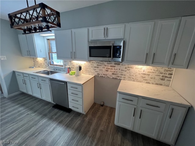 kitchen with white cabinetry, sink, dark wood-type flooring, and stainless steel appliances