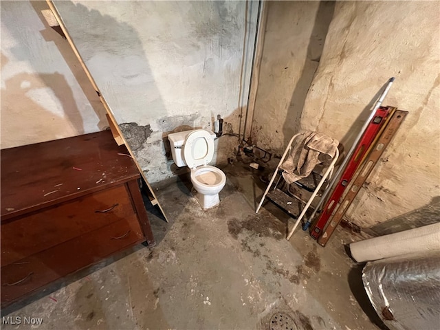 bathroom featuring concrete flooring and toilet