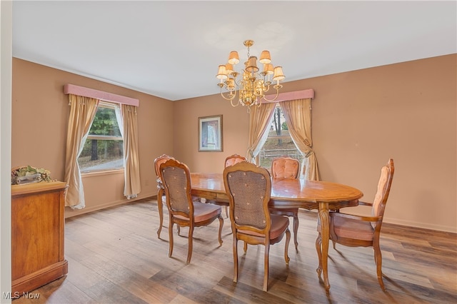 dining area featuring a notable chandelier and hardwood / wood-style flooring