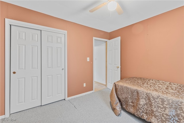 carpeted bedroom with a closet and ceiling fan