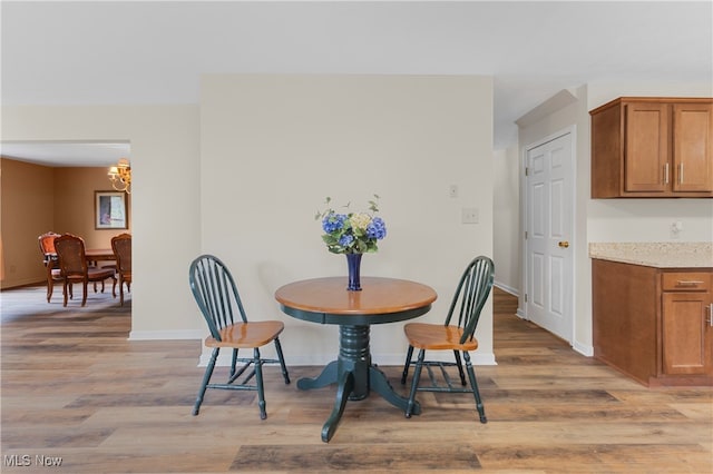 dining space with an inviting chandelier and light wood-type flooring