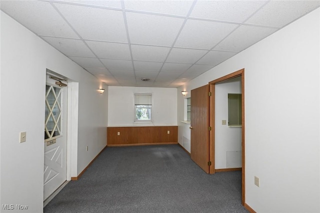 6942 State Route 44, Ravenna, OH 44266 - unfurnished room featuring dark carpet, a drop ceiling, and baseboards