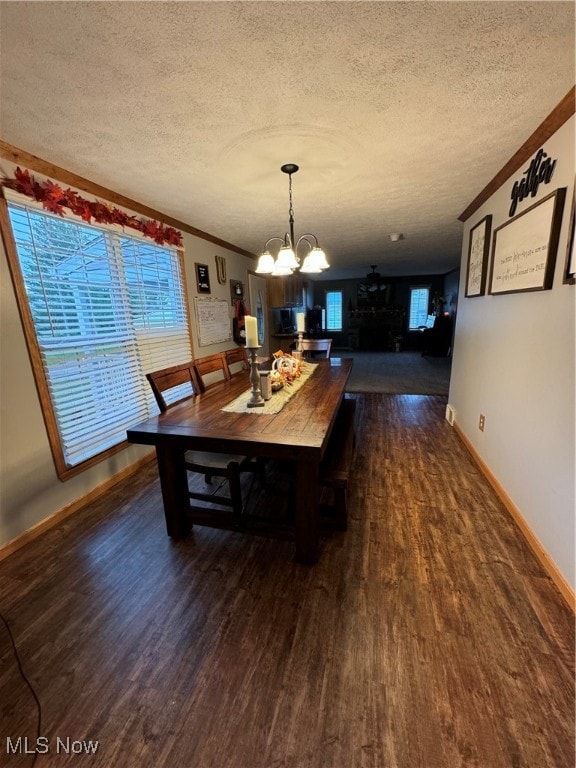 dining room featuring a notable chandelier, dark hardwood / wood-style floors, and a wealth of natural light