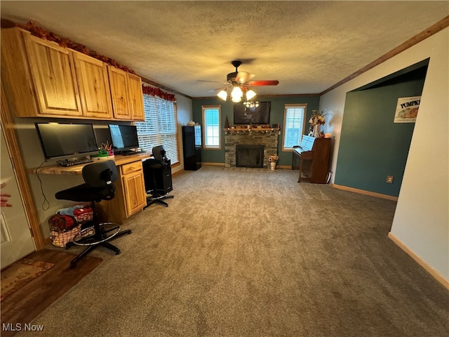 kitchen with a textured ceiling, a fireplace, ornamental molding, and ceiling fan