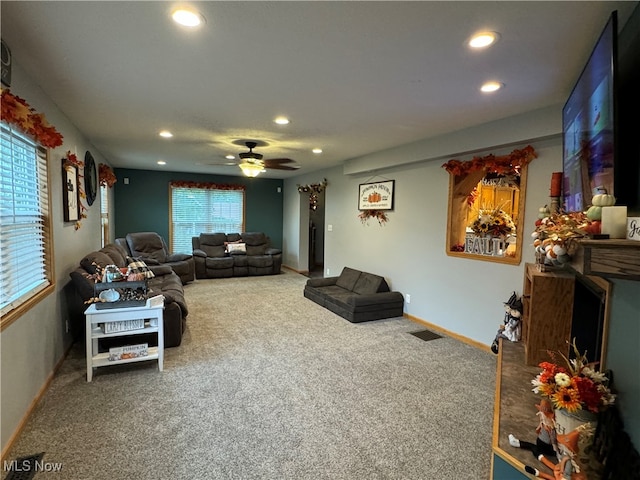 living room with a healthy amount of sunlight, carpet flooring, and ceiling fan