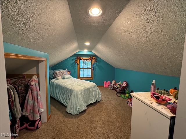 carpeted bedroom with a textured ceiling and lofted ceiling