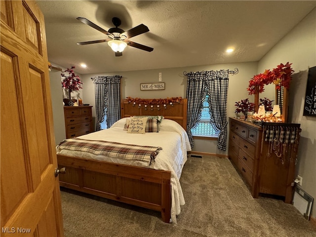 carpeted bedroom with a textured ceiling and ceiling fan