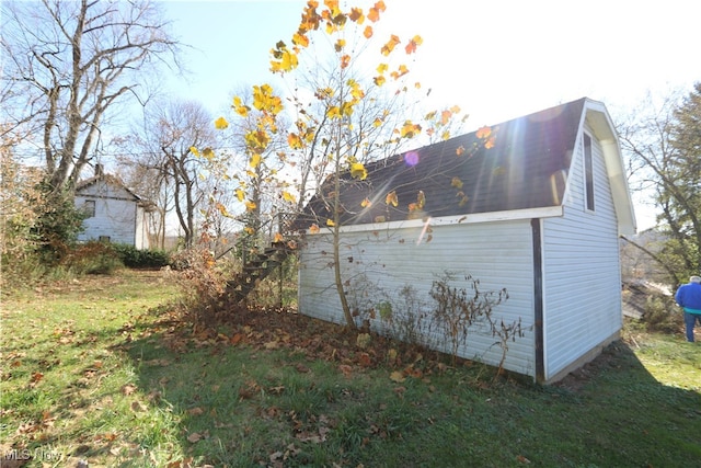 view of side of home with a lawn