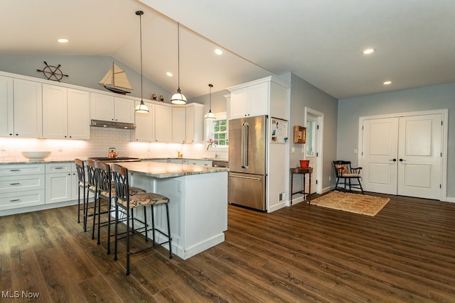 kitchen featuring white cabinetry, decorative light fixtures, high quality fridge, and dark wood-type flooring