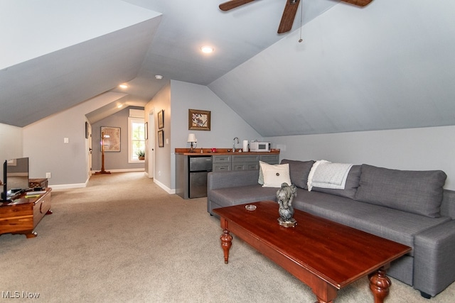 carpeted living room featuring sink, vaulted ceiling, and ceiling fan