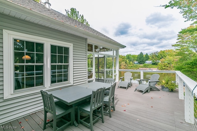 wooden deck with a sunroom