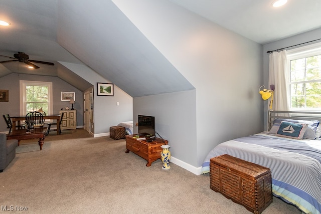 carpeted bedroom featuring multiple windows, lofted ceiling, and ceiling fan