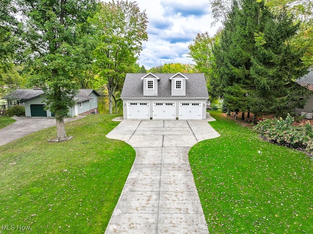 view of front of house with a front yard and a garage