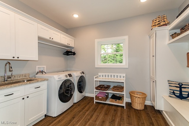 washroom featuring sink, independent washer and dryer, cabinets, and dark hardwood / wood-style flooring