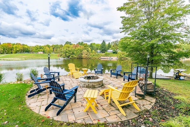 view of patio with a water view and an outdoor fire pit