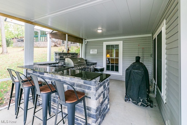 view of patio / terrace with grilling area and a bar