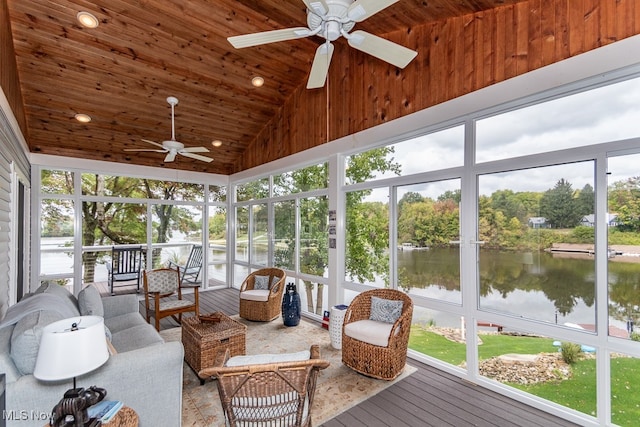 sunroom / solarium with vaulted ceiling, wood ceiling, a water view, and ceiling fan