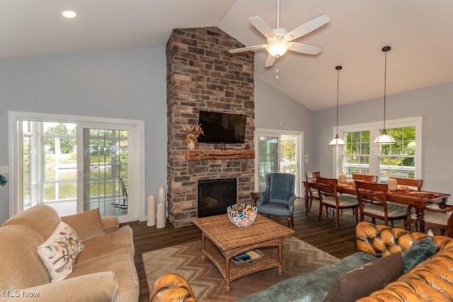 living room with high vaulted ceiling, dark wood-type flooring, a fireplace, and ceiling fan