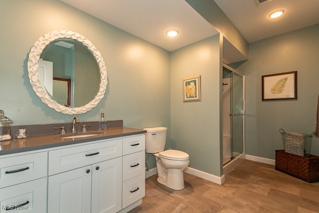 bathroom with vanity, an enclosed shower, hardwood / wood-style floors, and toilet