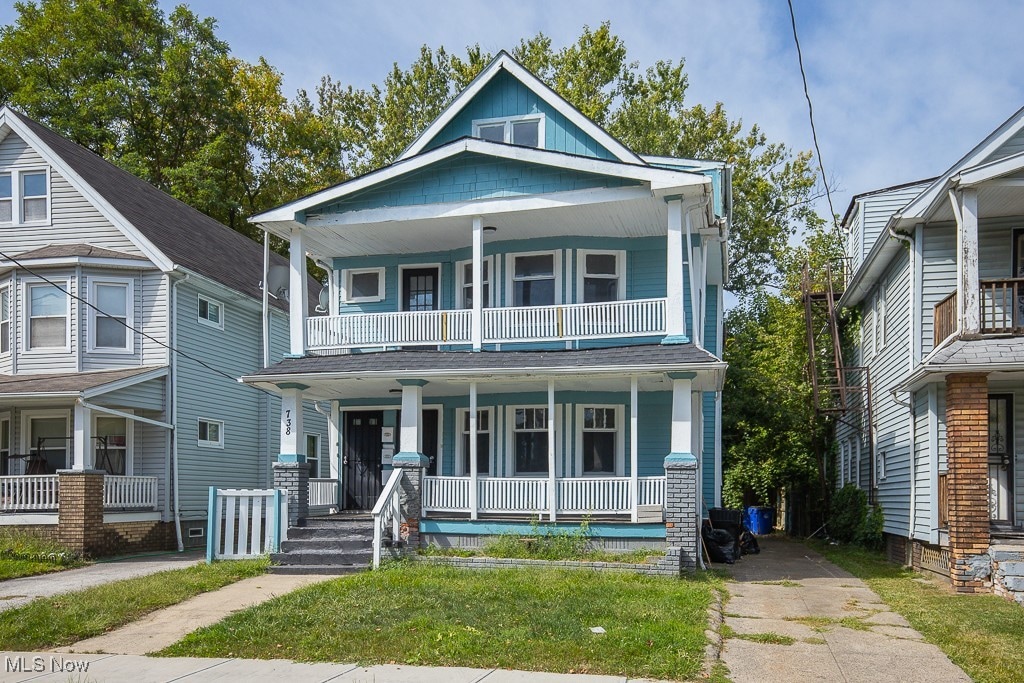 view of front facade featuring a balcony and covered porch