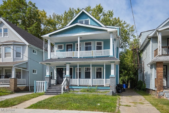 view of front facade featuring a balcony and covered porch