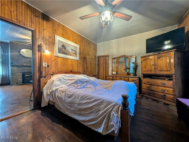 10206 Gillespie Run Rd, Petroleum, WV 26161 - bedroom with dark wood finished floors, wooden walls, and ceiling fan