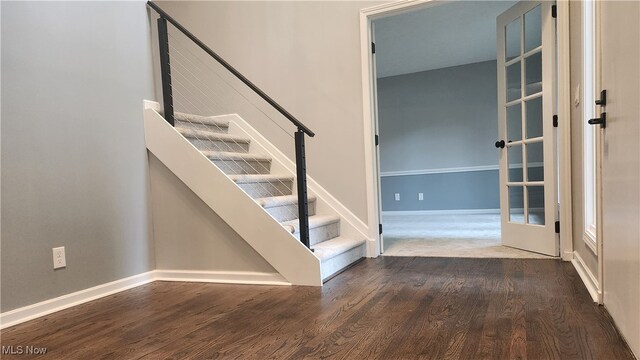 stairway with hardwood / wood-style floors