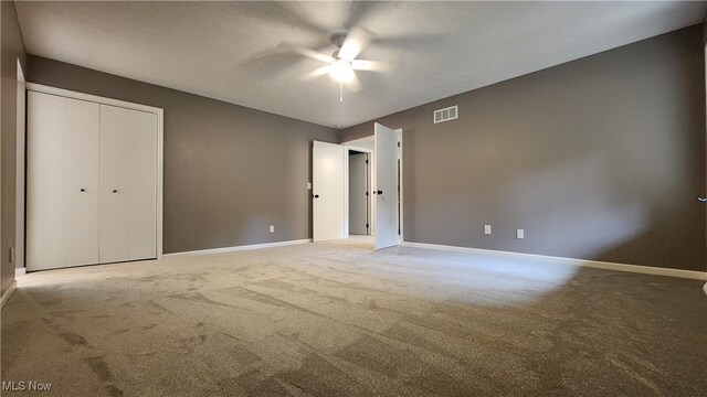 interior space featuring light carpet, a closet, and ceiling fan