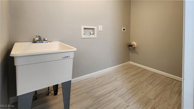 washroom with light hardwood / wood-style flooring, hookup for an electric dryer, and hookup for a washing machine