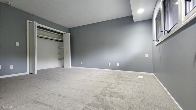 unfurnished bedroom with a closet and carpet flooring