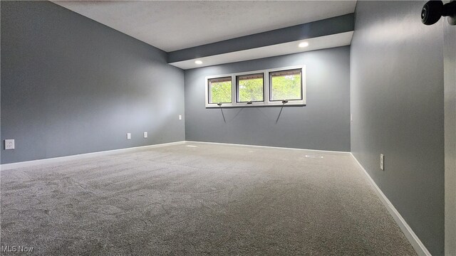 carpeted empty room featuring a textured ceiling