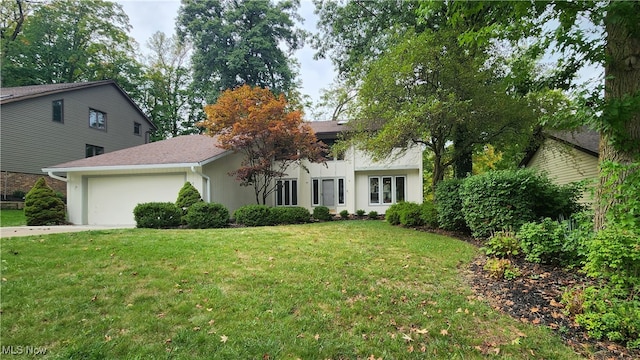 view of front of property featuring a garage and a front yard