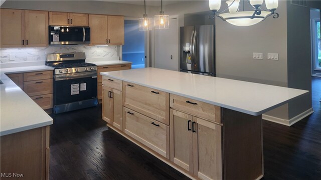 kitchen featuring hanging light fixtures, a kitchen island, a chandelier, stainless steel appliances, and dark hardwood / wood-style floors