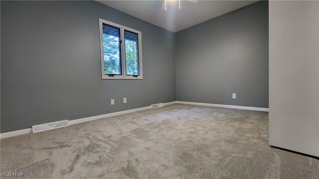 empty room featuring carpet floors and ceiling fan