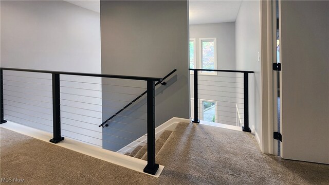 hallway with light colored carpet