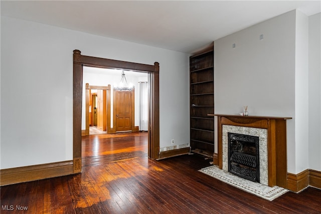 unfurnished living room featuring dark hardwood / wood-style flooring