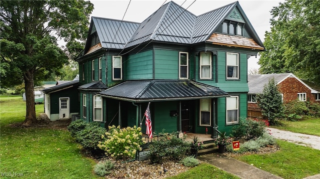 view of front of home with a porch and a front lawn