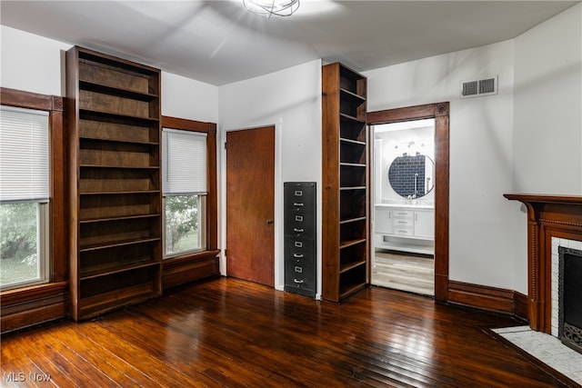 unfurnished living room with dark wood-type flooring