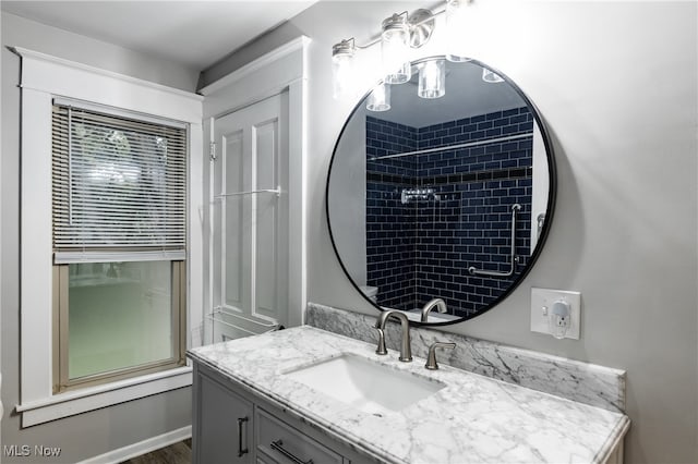 bathroom with tiled shower / bath combo and vanity